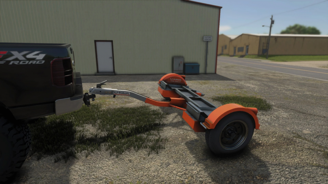 FS25 Tow Dolly v1.0.0.0 mod in Farming Simulator 25, attached to a truck, used for transporting trailers, with a U-Haul logo on the dolly.