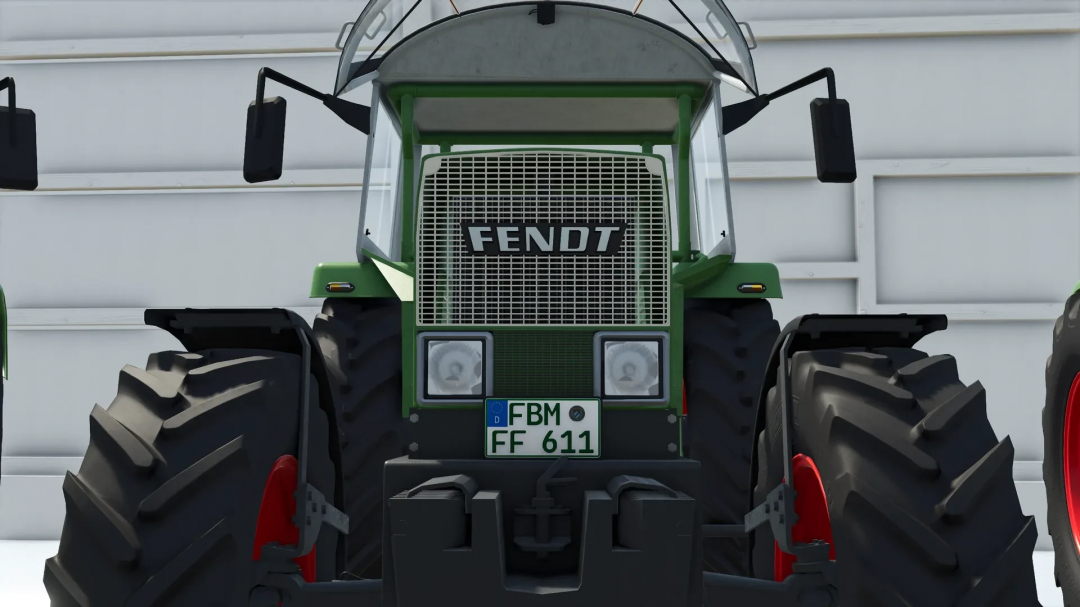Front view of a green Fendt tractor in Farming Simulator 25 mod, showing its grille, headlights, and large tires with red rims.
