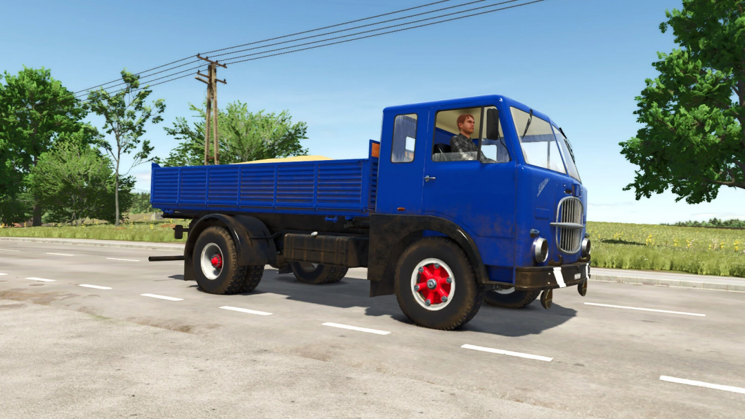 Farming Simulator 25 mod: Blue Fiat 682 N4 truck with red wheels on a rural road during daytime.