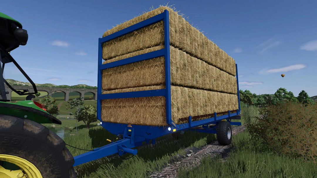 FS25 mod: Blue bale trailer filled with hay bales for farming simulator 25.