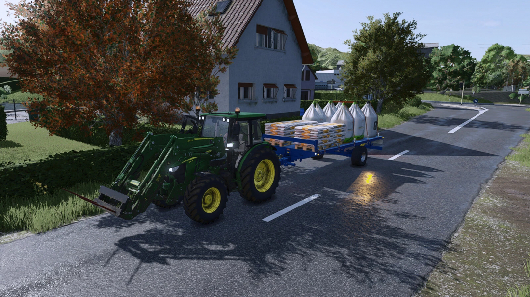 Farming Simulator 25 mod featuring a green tractor with a bale trailer loaded with hay bales and seed bags on a rural road.