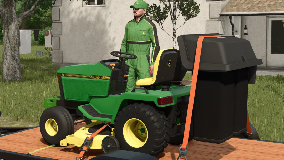 Farming Simulator 25 mod featuring a John Deere 445 tractor with utility attachments, shown outdoors on a grassy area with a character nearby.