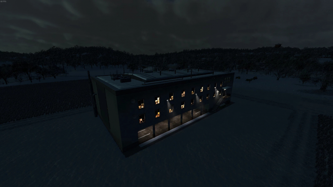 Night view of the Large Decorative Building mod from Farming Simulator 25, showcasing illuminated windows and a modern structure.