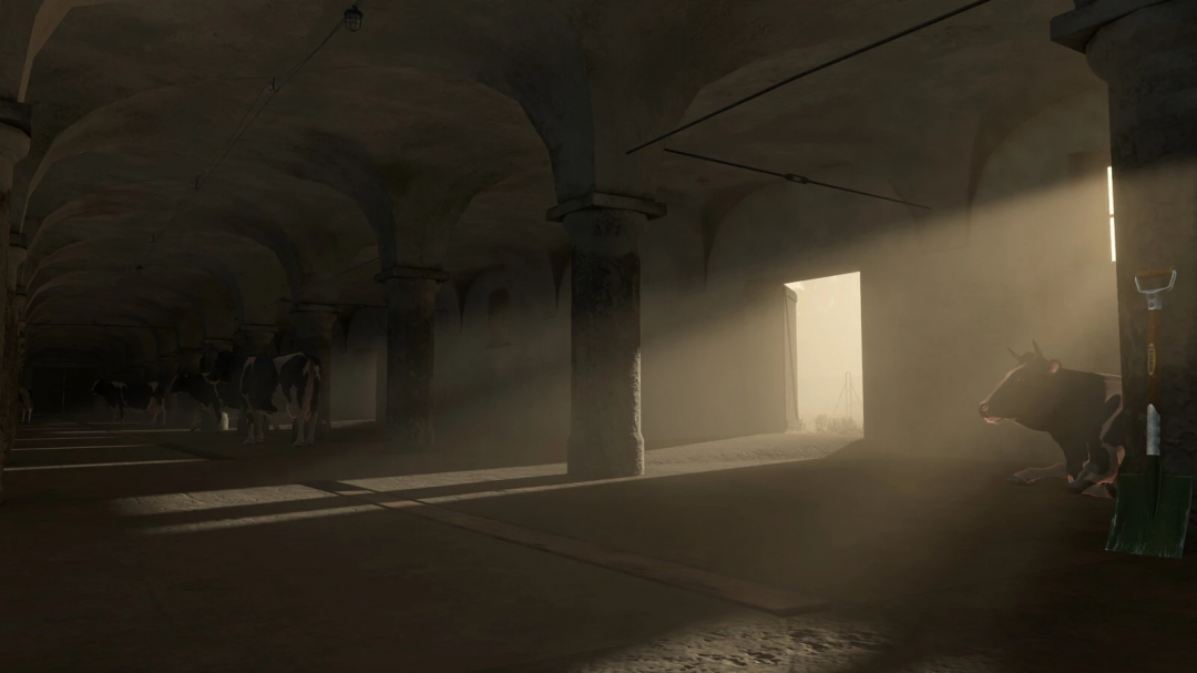 Inside a barn with cows resting, sunlight streams through an open door illuminating dust and pillars, showcasing Farming Simulator 25 mods.