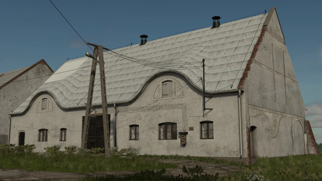Farming Simulator 25 mods: PGR Animal Barns Pack v1.0.0.0 building with a curved roof, utility poles, and grass in front.
