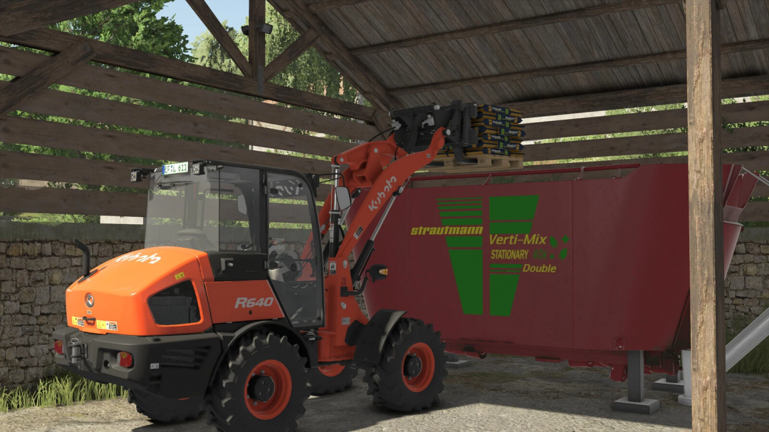 Farming Simulator 25 mod: Kubota R640 loader equipped with a KOHLER mineral feed bucket, stored in a farm shed.