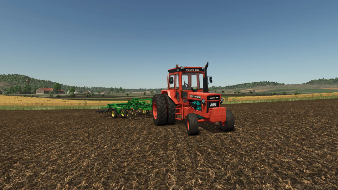 Farming Simulator 25 mod: Volvo BM 2650 tractor plowing fields with green implement in a rural landscape.