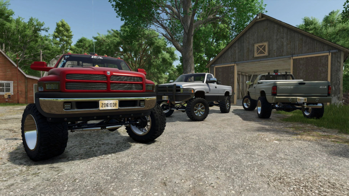 fs25-mods,  Farming Simulator 25 mods: three modified Dodge Ram trucks parked in a rural yard, including a red, silver, and gray truck with lifted suspensions.
