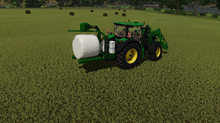 fs25-mods, Farming Simulator 25 mod featuring a McHale 991 round baler attached to a green tractor in a field.