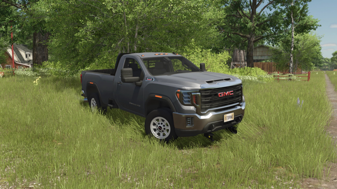 GMC Sierra 3500HD pickup truck mod from Farming Simulator 25, parked in a grassy field with trees and a dirt path nearby.
