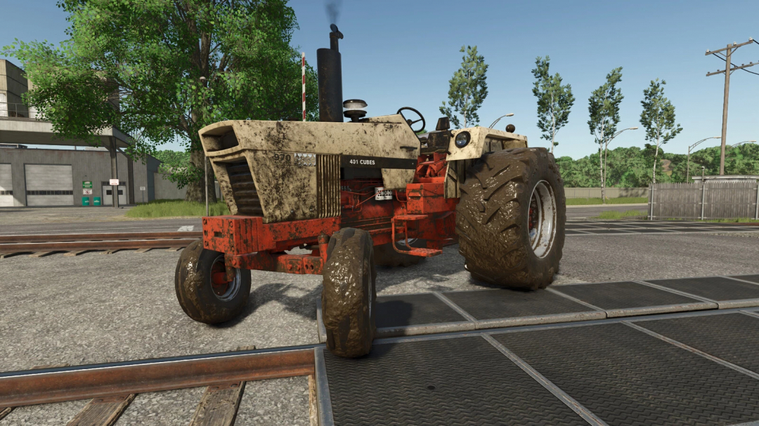 Farming Simulator 25 mod: vintage tractor with muddy tires and worn paint, used for agricultural work in FS25 game.