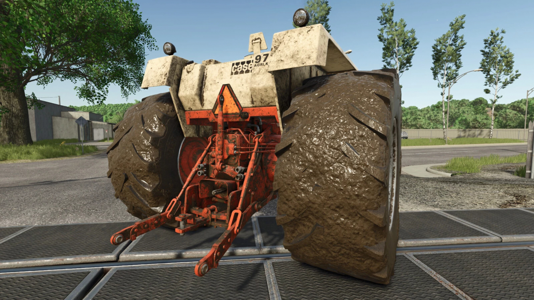 Farming Simulator 25 mod: Case 970, 1070 Agri King tractor with muddy tires, outdoor environment, used in Farming Simulator 25.