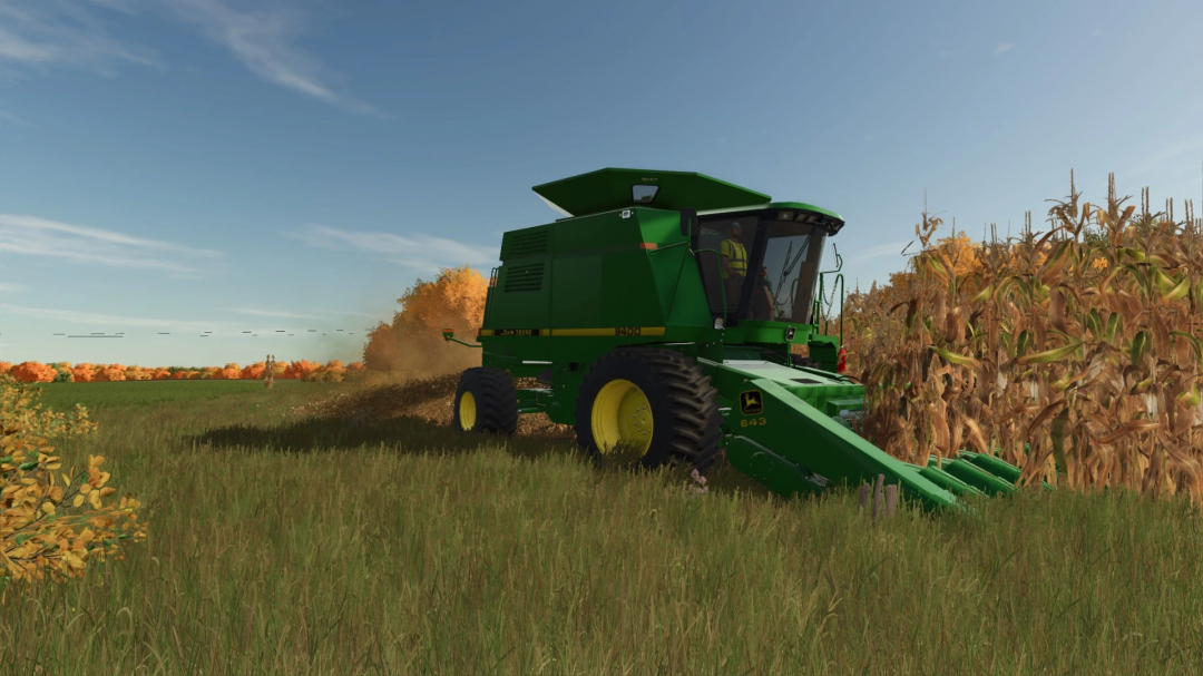 Farming Simulator 25 mod: Green John Deere 43 Series Corn Head harvesting maize in a field, with clear blue sky, for FS25 mods.