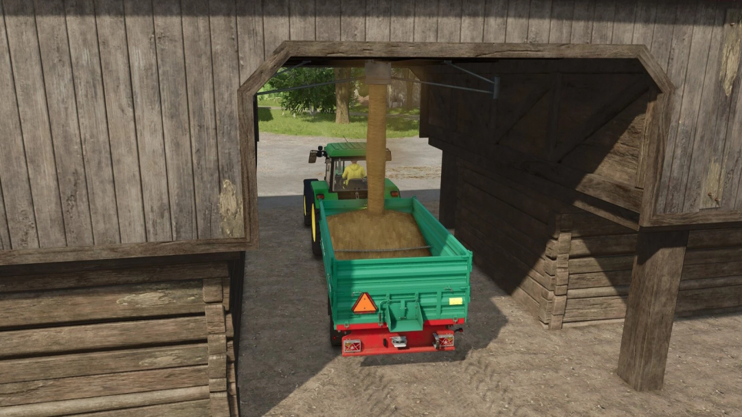 Farming Simulator 25 mod: tractor loading harvested grass into a green trailer with a grass-dryer and storage setup.