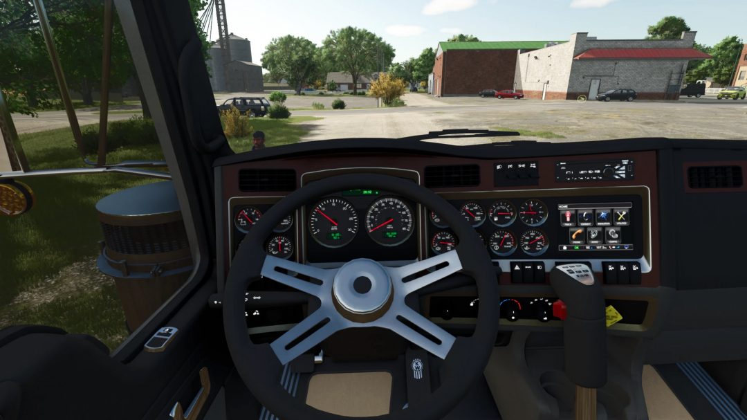 Interior view of a truck in Farming Simulator 25 showing dashboard and steering wheel, with a barnyard scene outside.