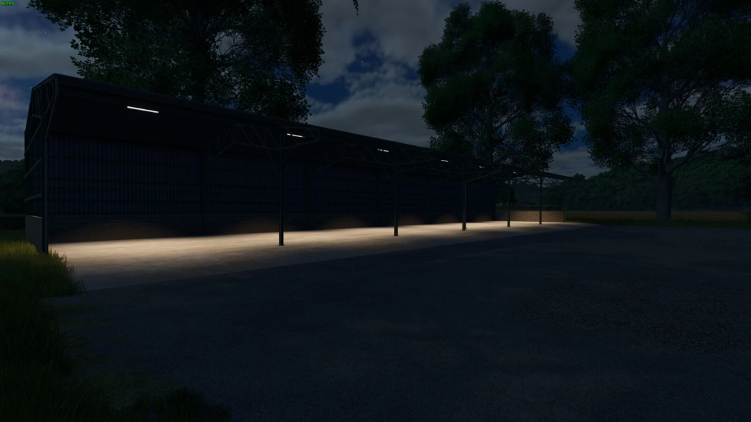 Night view of the Metal Shed 45m from FS25 mods in Farming Simulator 25, illuminated under a cloudy sky.