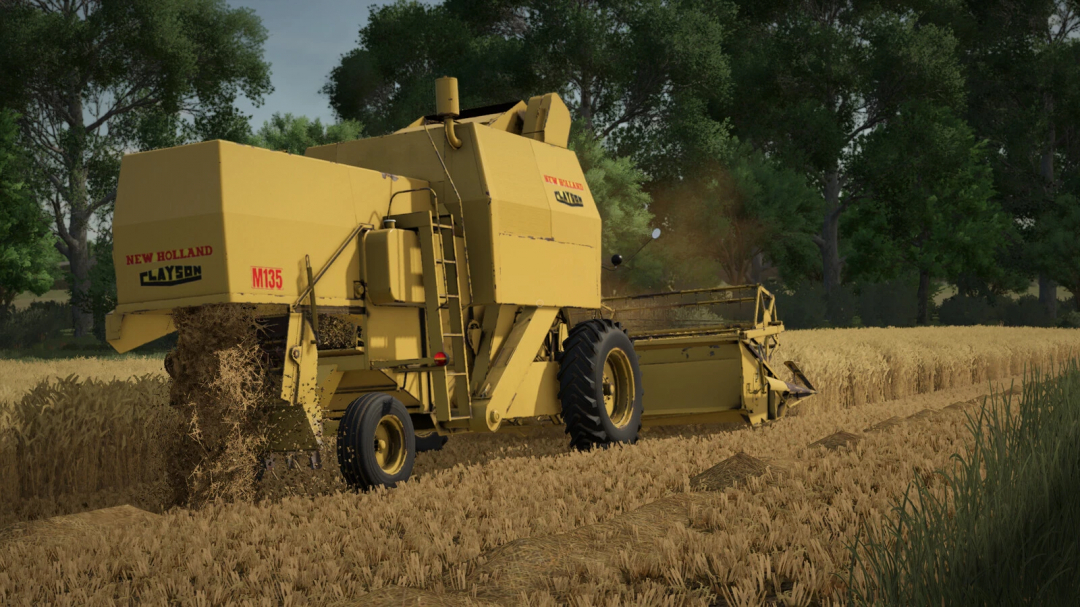 Farming Simulator 25 mod: New Holland M135 baler working in a wheat field, with trees and blue sky in the background.