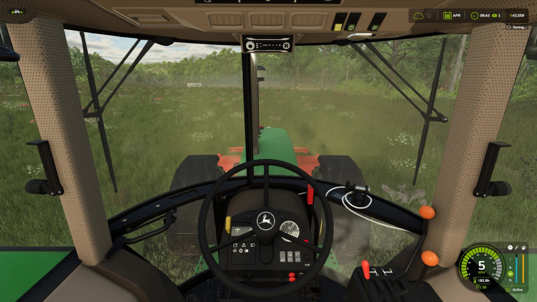 Inside view of a tractor in Farming Simulator 25 mod, with steering wheel and dashboard, dust on the windshield, and green fields outside.