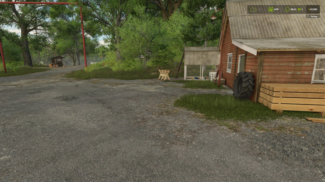 Farming Simulator 25 mod scene with rural gravel road, red wooden barn, large tractor tire, and lush green trees, showcasing FS25 mods.