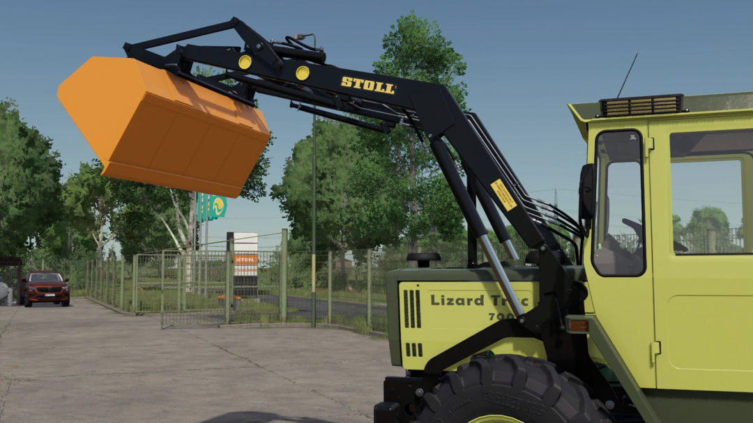 FS25 mod: Lizard Trac front loader with Stoll Super 1 bucket for Farming Simulator 25. Agricultural machinery in a farmyard setting.