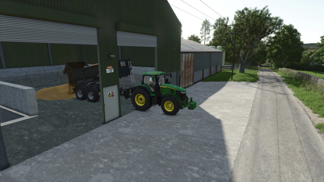 Farming Simulator 25 mods: Green tractor with tip anywhere mod v1.0.1.0 unloading grain into a storage shed.