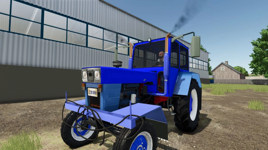 Farming Simulator 25 mod: UTB 650 configurable tractor parked outside a farm building.