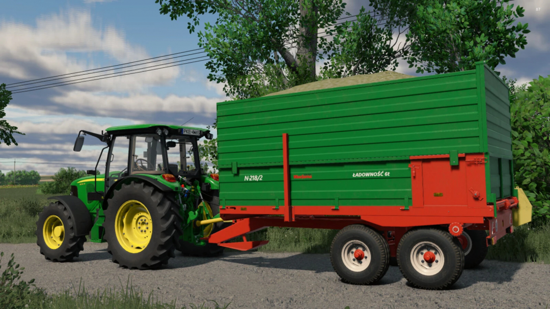 Farming Simulator 25 mod featuring Warfama N218 grain trailer attached to a green tractor in FS25.